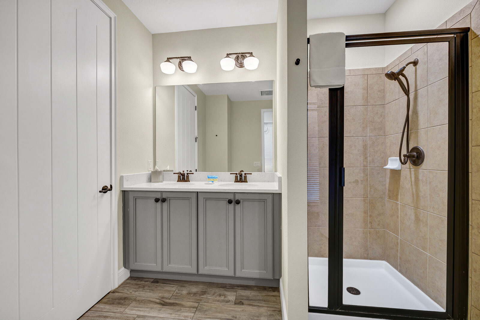Bathroom with double sinks and shower