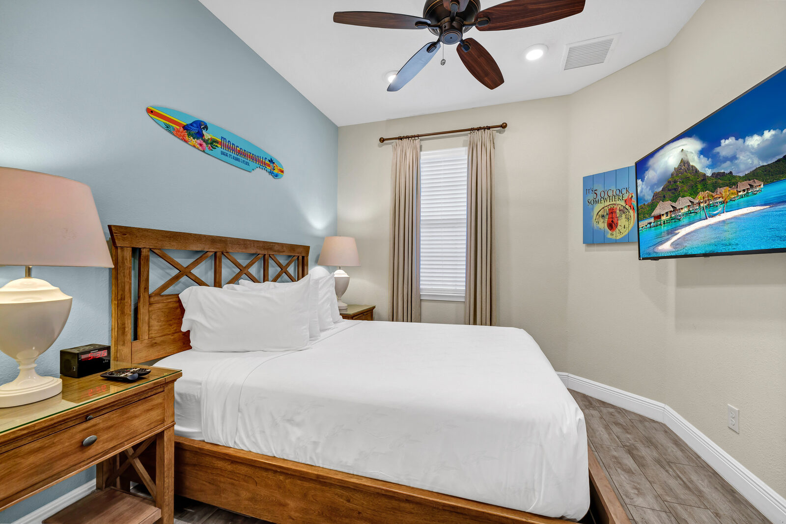Queen bedroom with coastal artwork