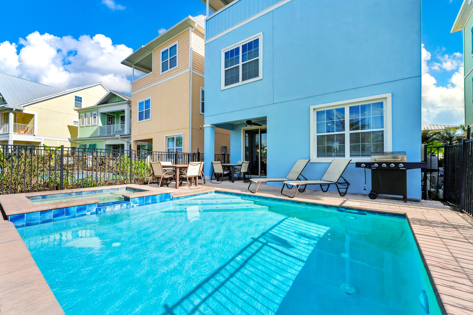Pool deck with gas grill, loungers and dining table